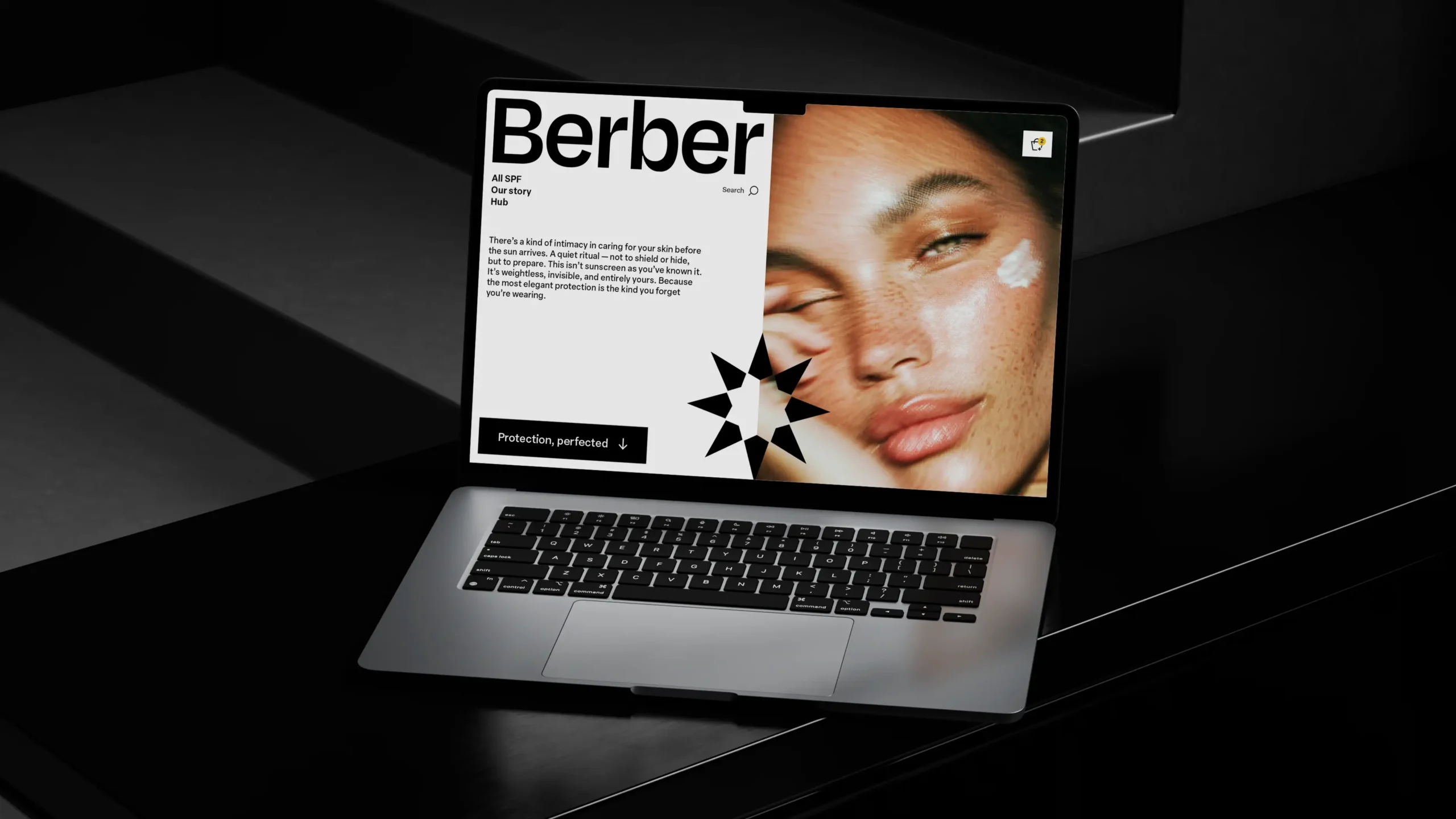 Berber skincare website on laptop, featuring model with sunscreen, elegant design.