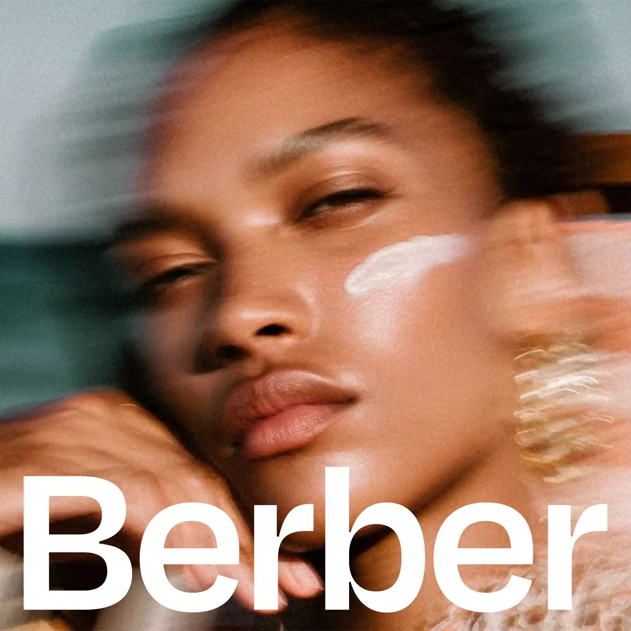Close-up of model with sunscreen, Berber logo overlay, healthy skin, motion blur.