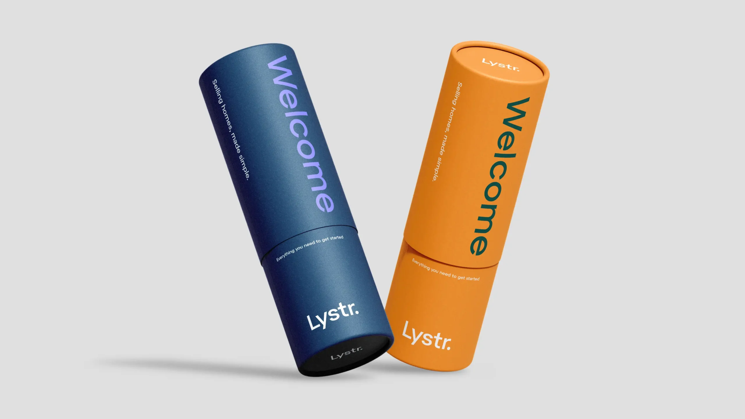Two Lystr "Welcome Packs" cylindrical packaging tubes.